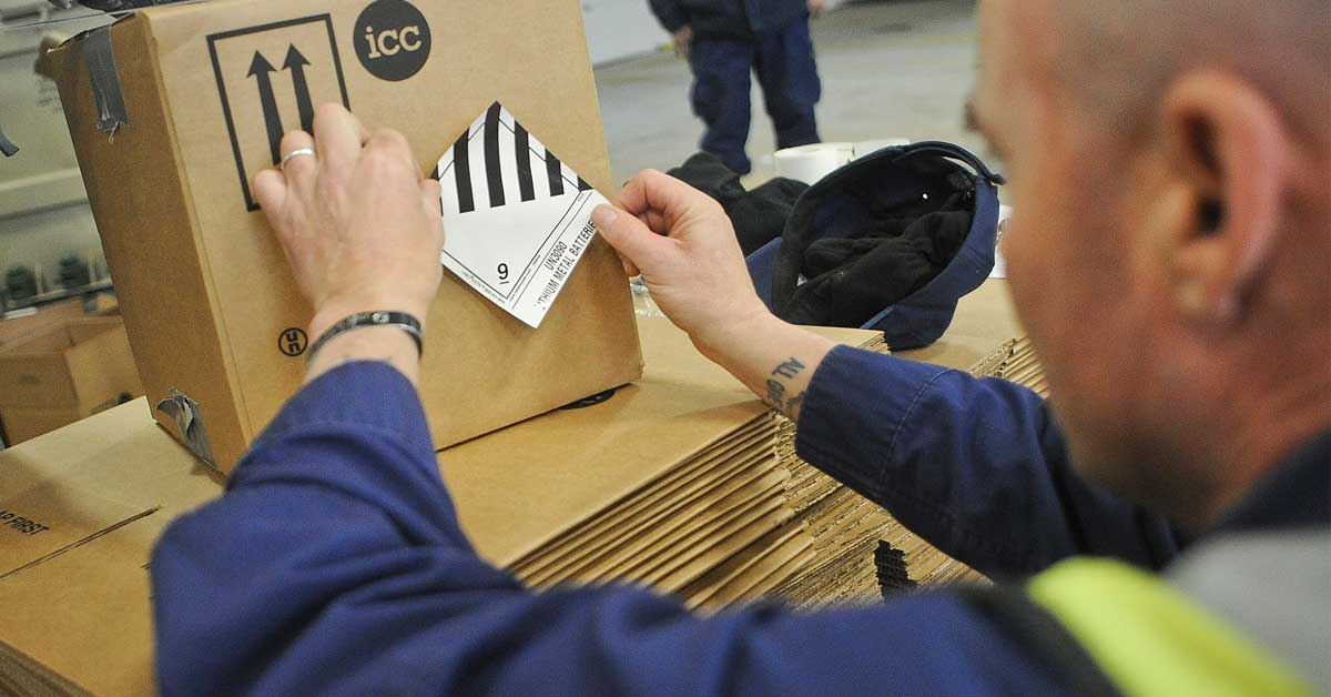 Photo of a person preparing a hazmat package for proper shipping.