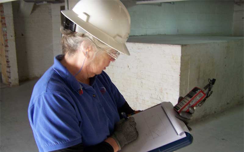 A Old Lady Viewing Blue Print Of Construction Site